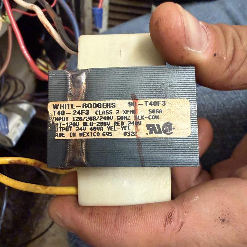 White Rodgers transformer held by technician fingers