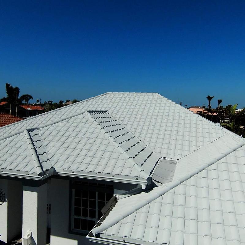 Concrete tile roof with white tiles under clear sky Concrete tile roof with white tiles under clear sky