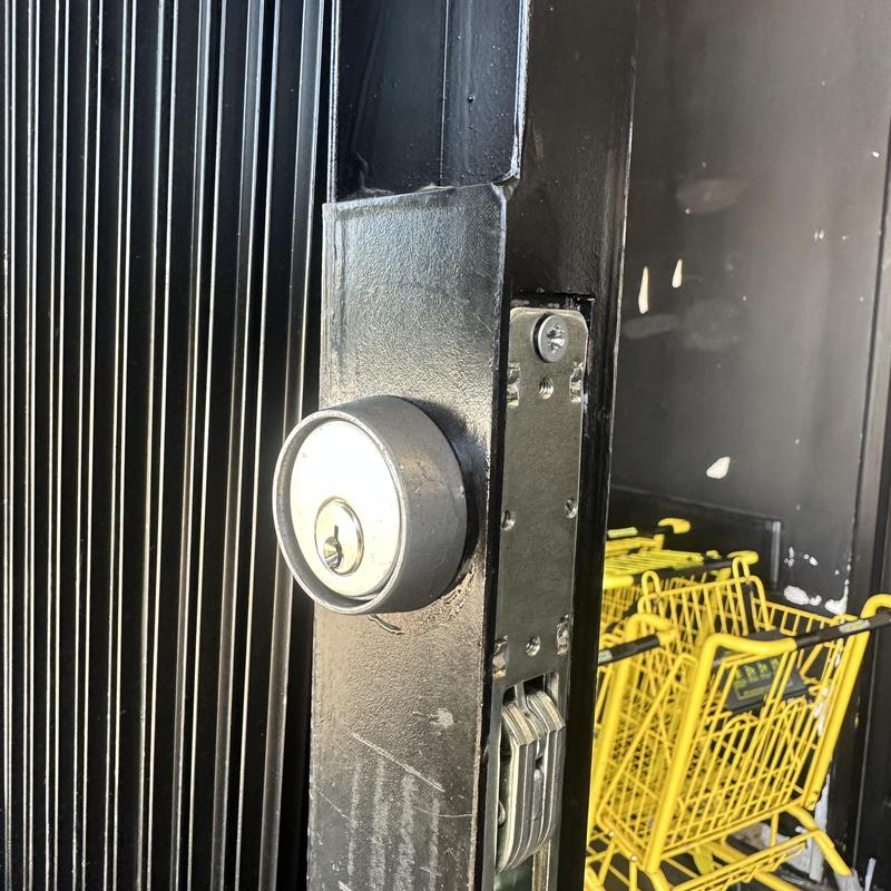 Security gate cylinder lock with latch bolt installed