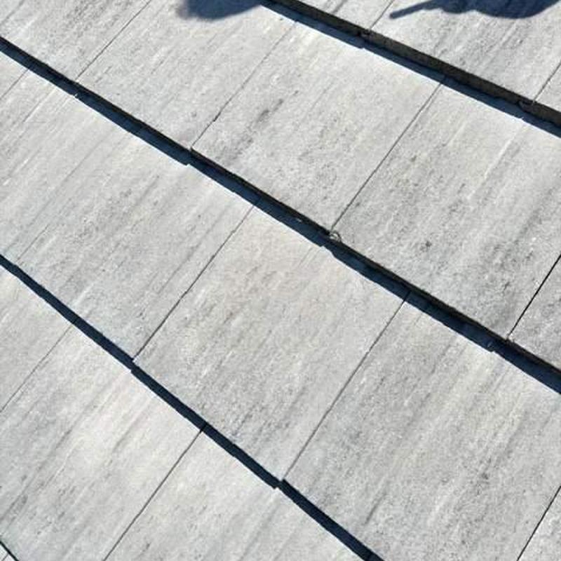 Concrete roof tiles with resecured loose tiles Concrete roof tiles with resecured loose tiles