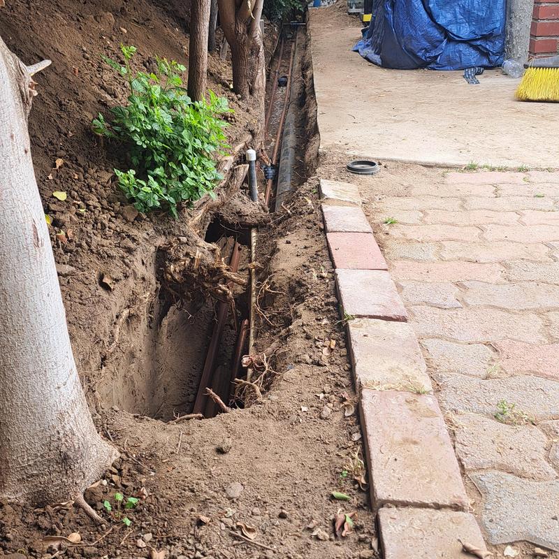 Gas and water line trench excavation alongside house Gas and water line trench excavation alongside house