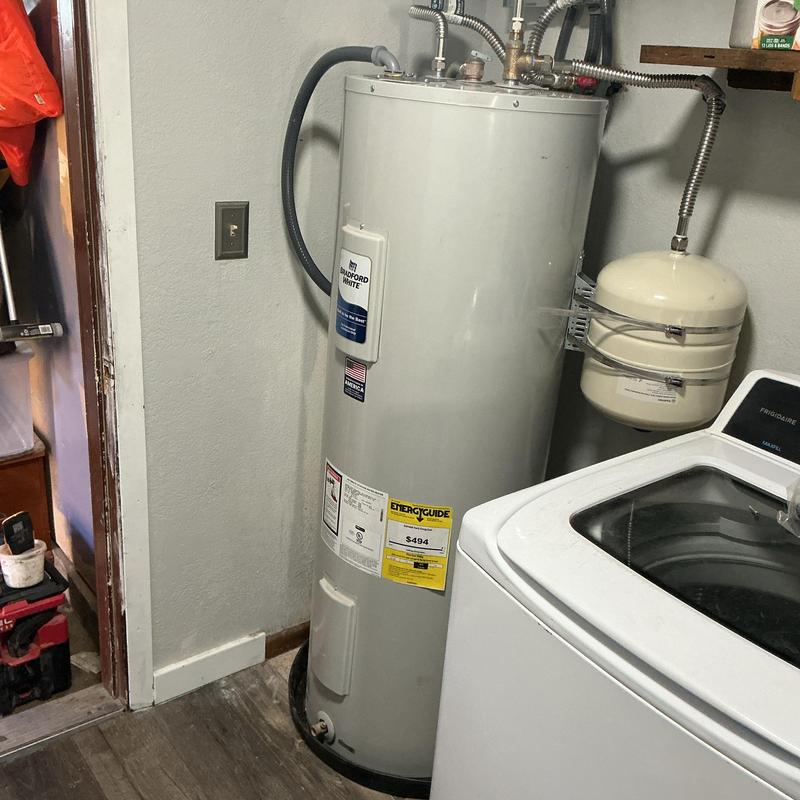 Water heater with expansion tank in laundry room Water heater with expansion tank in laundry room