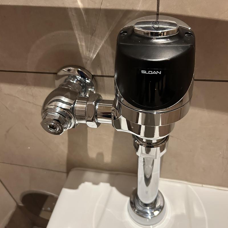 Toilet flush valve with sensor on commercial toilet