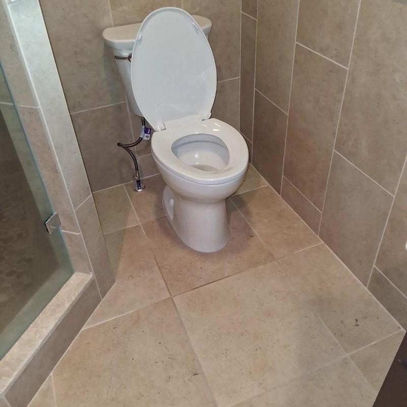 Toilet installation in tiled bathroom corner