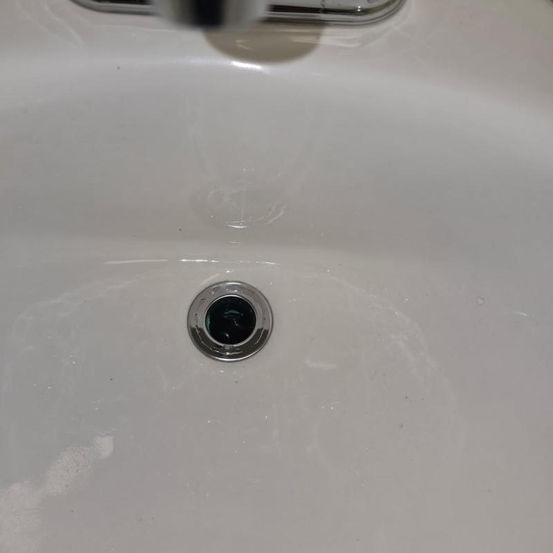 Lav faucet and drain in white wall hung sink