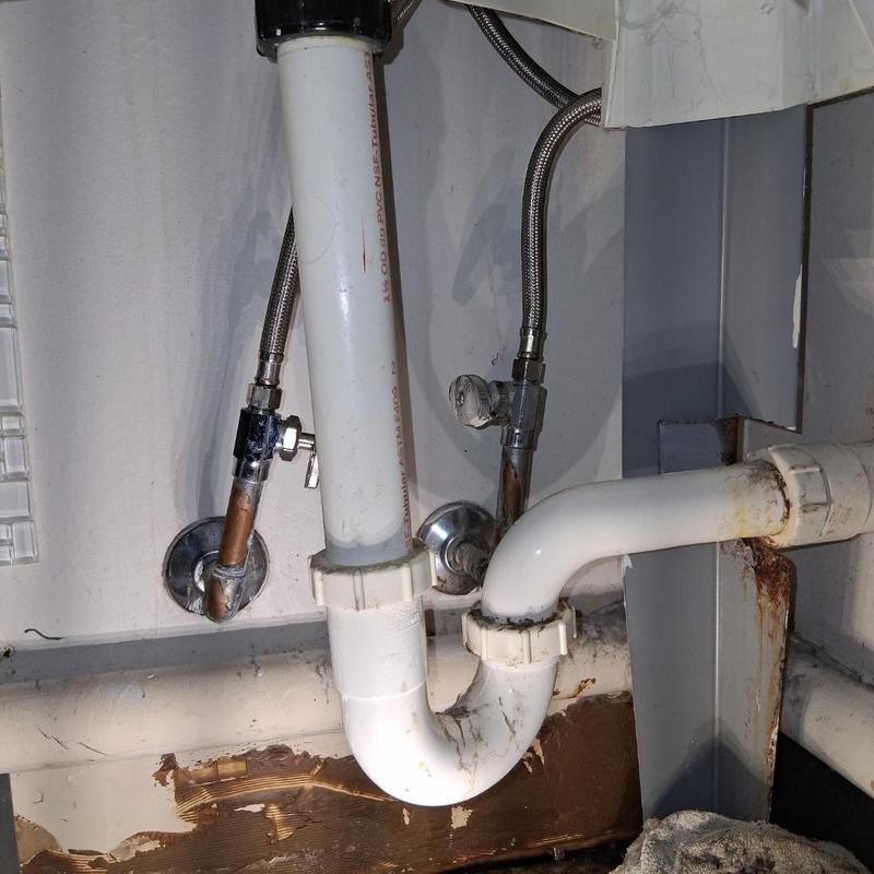Stop valve with braided supply lines under sink plumbing