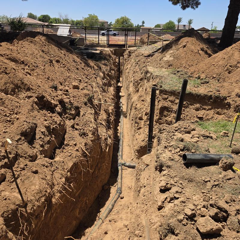 13-foot deep sewer line trench with black pipes 13-foot deep sewer line trench with black pipes