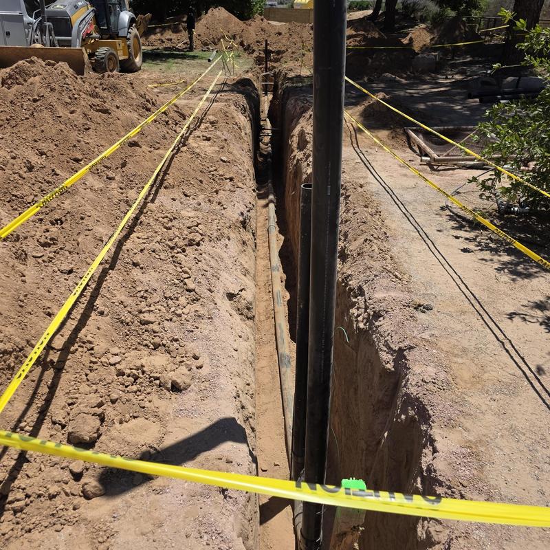 Sewer line trench excavation with caution tape Sewer line trench excavation with caution tape
