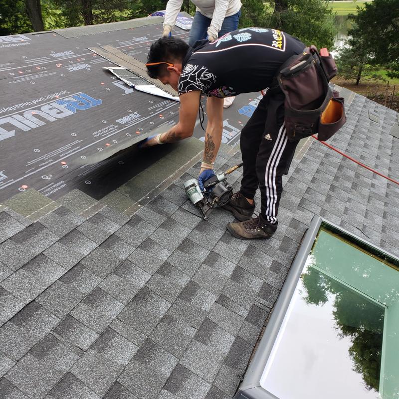 GAF asphalt shingle roof installation near Velux skylight GAF asphalt shingle roof installation near Velux skylight
