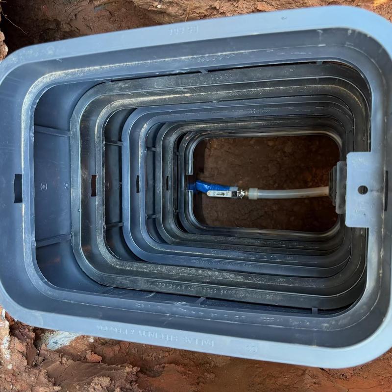 Water service line inside valve box in ground