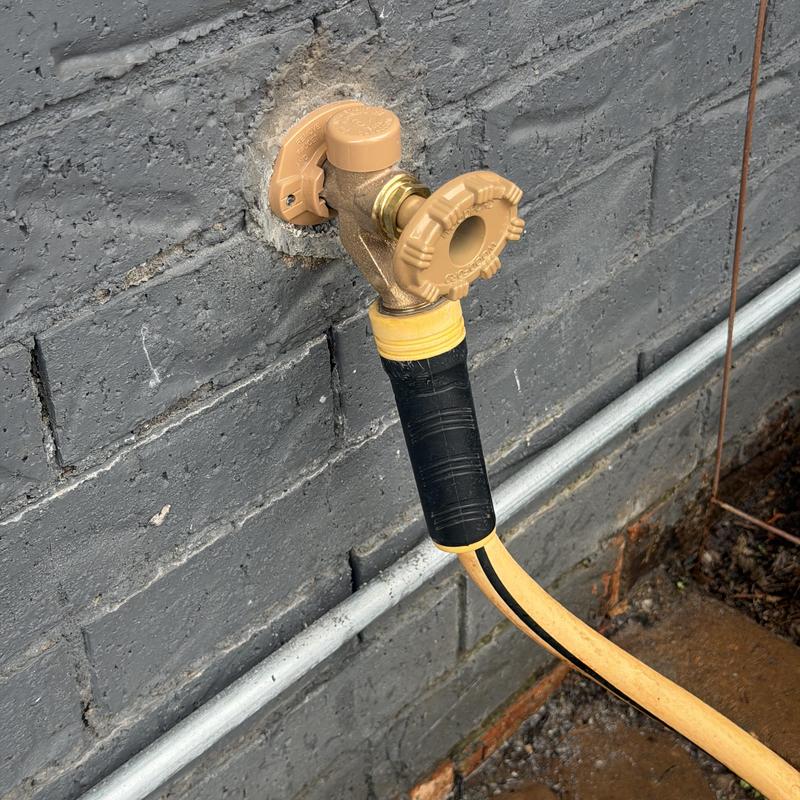 Frost proof sillcock with garden hose attached Frost proof sillcock with garden hose attached