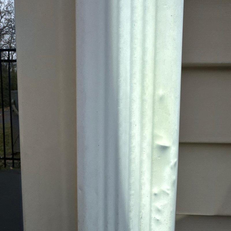 Metal flashing with dents from hail damage