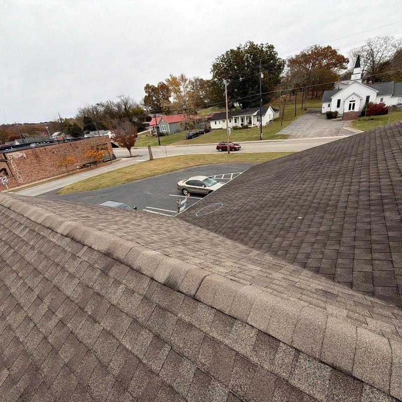 Daycare facility roof ridge with shingle wear and damage
