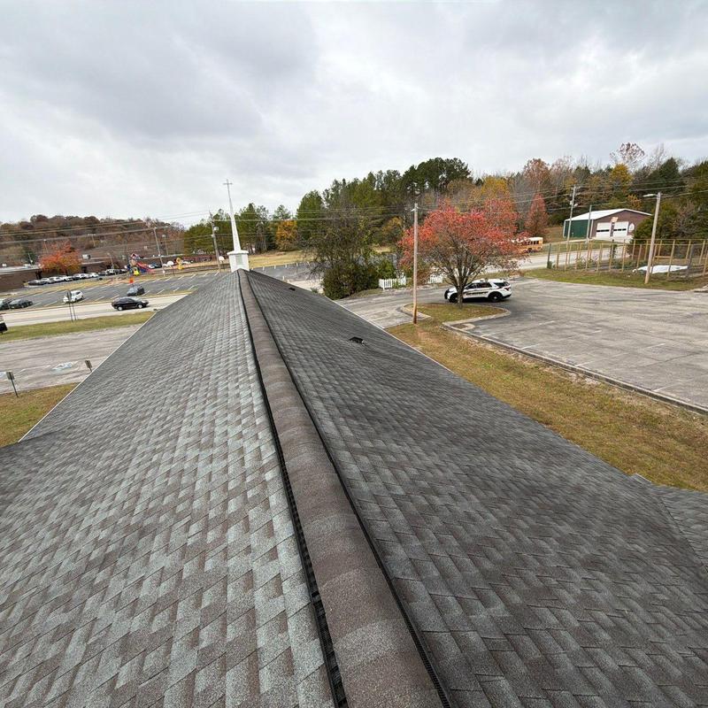 Church roof ridge shingles with hail damage