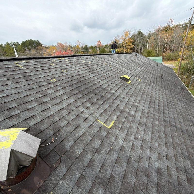 Asphalt shingle roof with hail damage markings and inspections