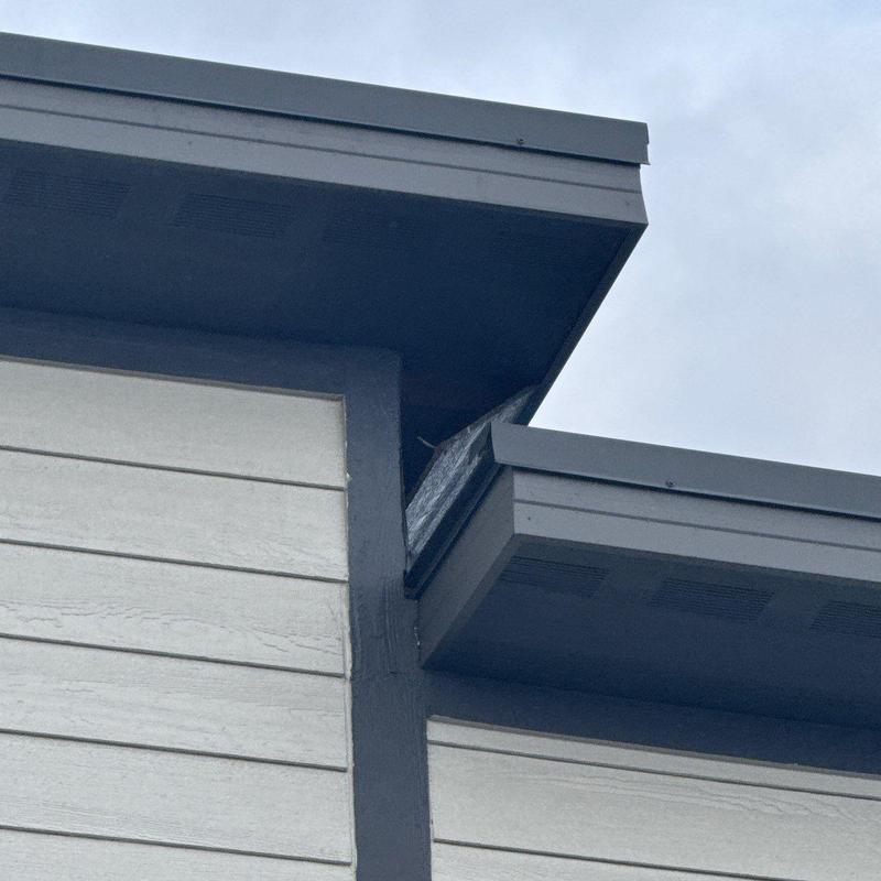 Roof flashing and ventilation inspection on multi-unit building