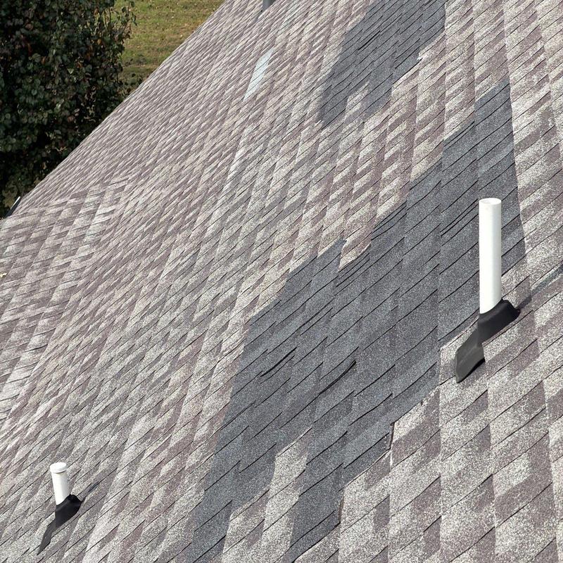 Roof shingles with hail damage near vent pipes