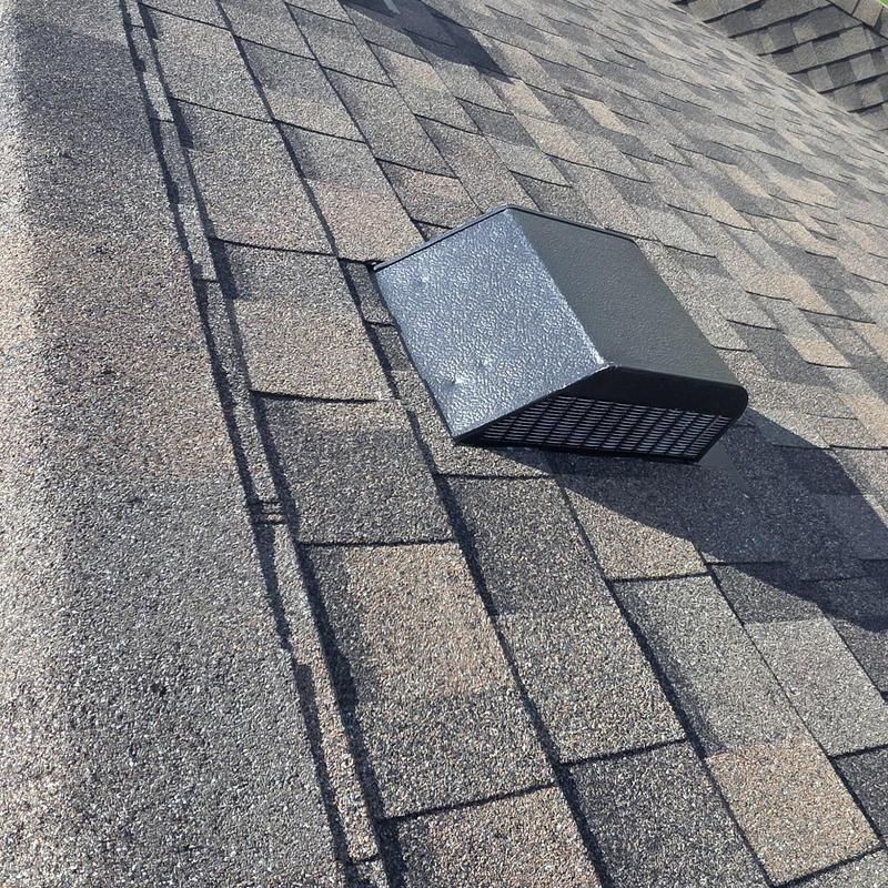 Roof shingles with hail damage near vent cover