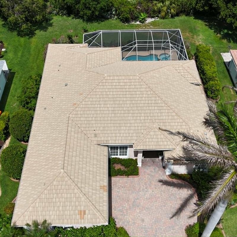 Concrete tile roof with pool enclosure above backyard