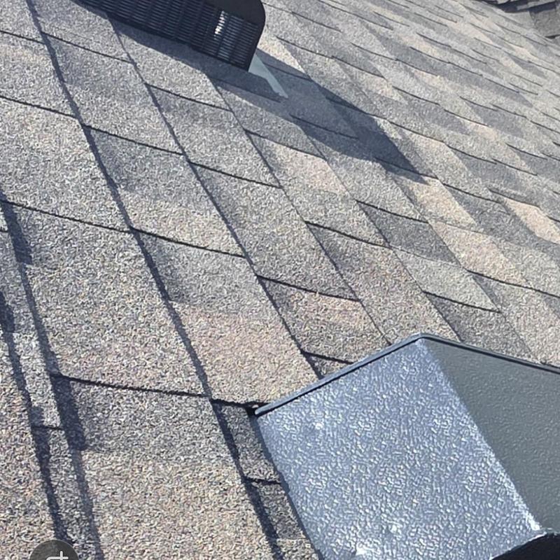 Asphalt shingle roof with hail damage near vent cap