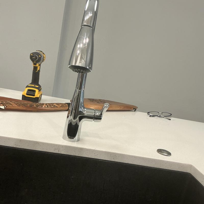 Single handle kitchen faucet on white countertop