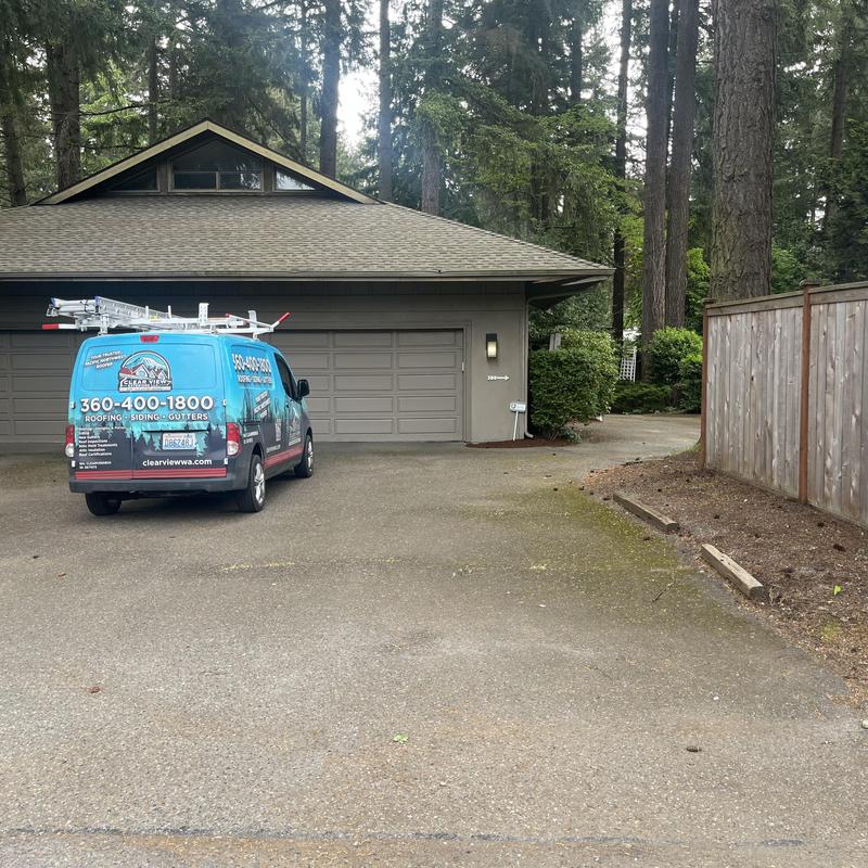 Shingle roof with roofer van parked in driveway Shingle roof with roofer van parked in driveway