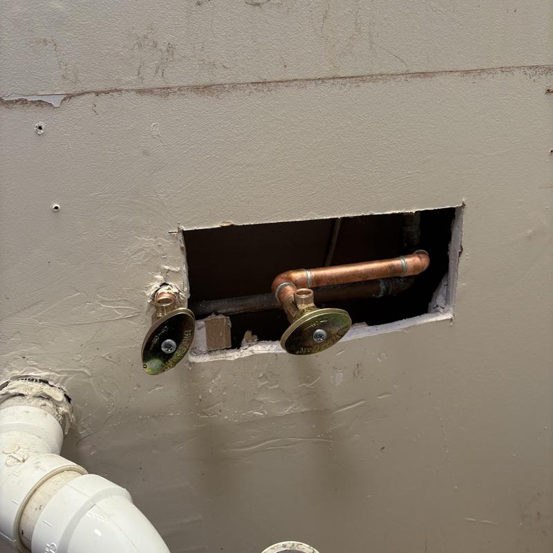 Emergency shut off valves with copper piping in wall cavity