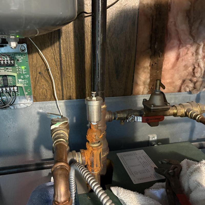 Boiler hyvent vent pipe with rust and valve nearby