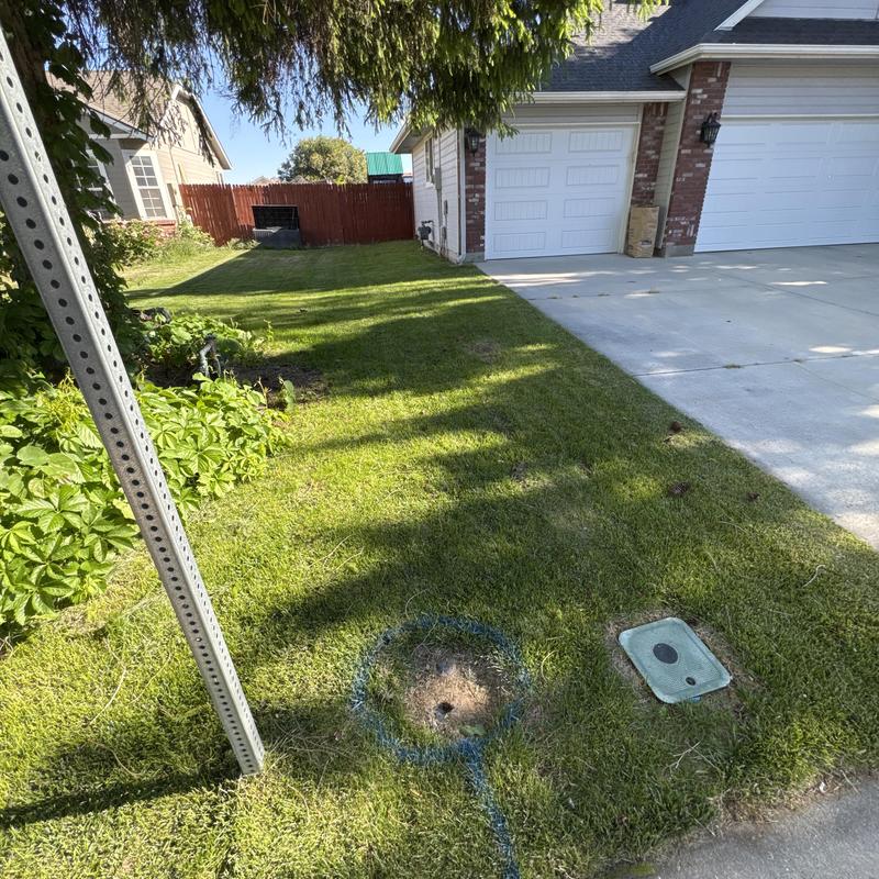 Water main pipe replacement site with marked excavation area
