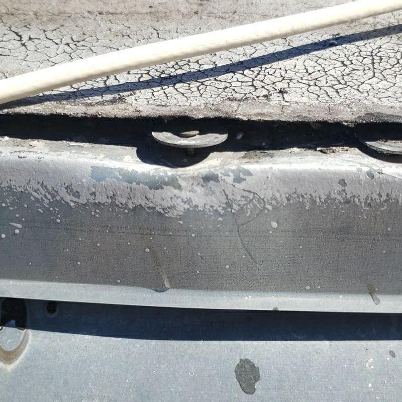Flat roof seams detaching with cracked surface and fasteners Flat roof seams detaching with cracked surface and fasteners