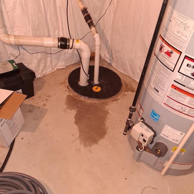 Sump pump system with discharge pipes in basement