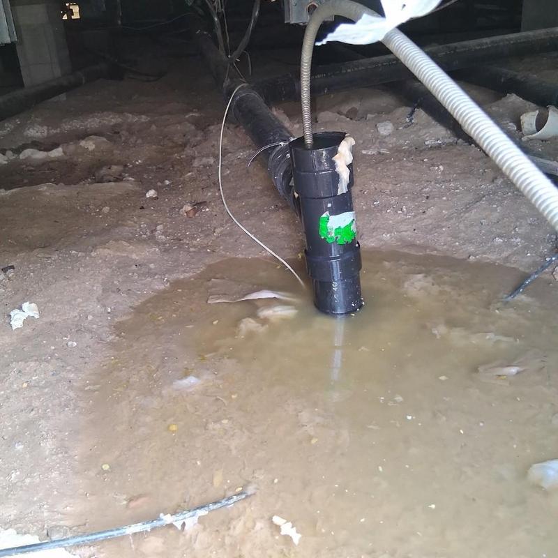 Main drain pipe with water backup in crawl space