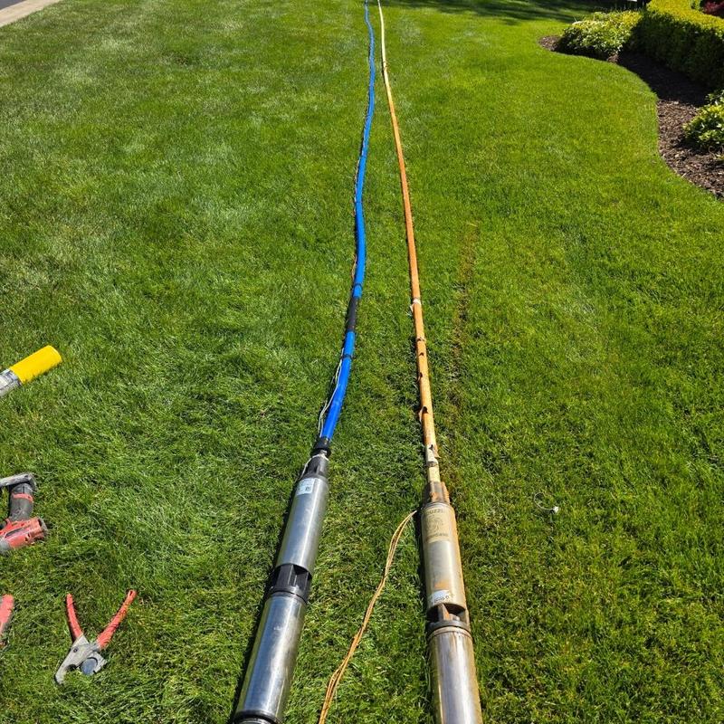 Submersible deep well pumps with wiring on grass
