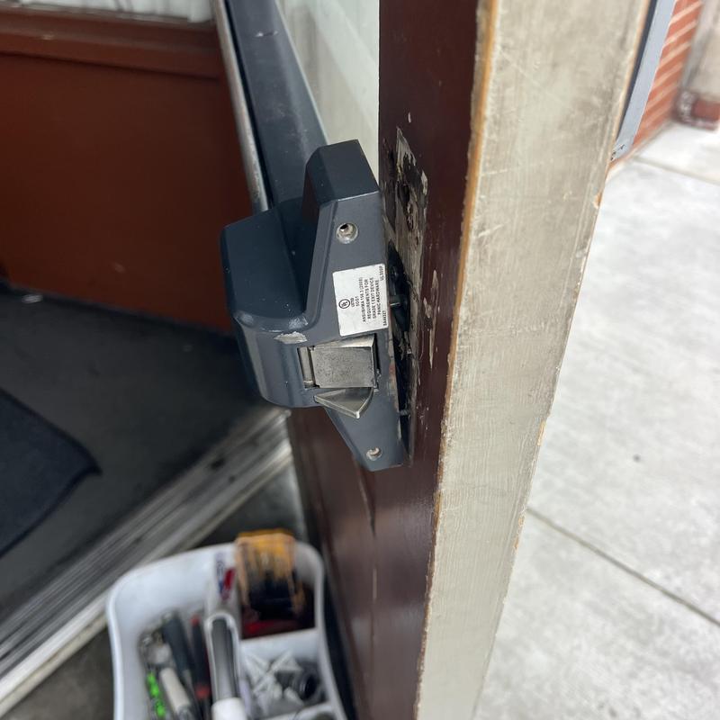 Exit device latch on door being reattached