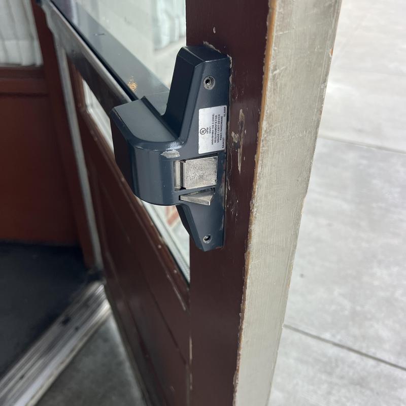 Exit device latch on door frame detail Close-up