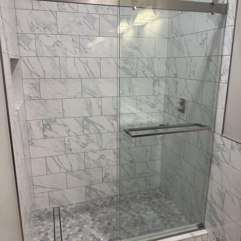 Shower glass door with metal trim kit installed