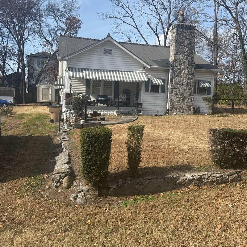 Asphalt shingle roof with hail damage and chimney stonework
