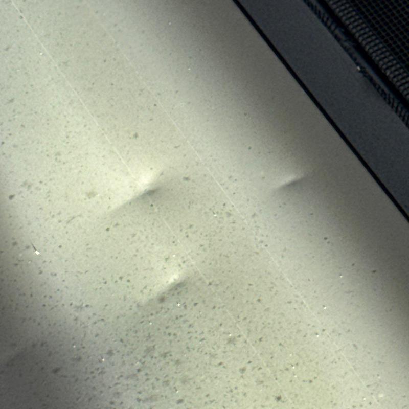 Asphalt shingles with hail damage dents close-up