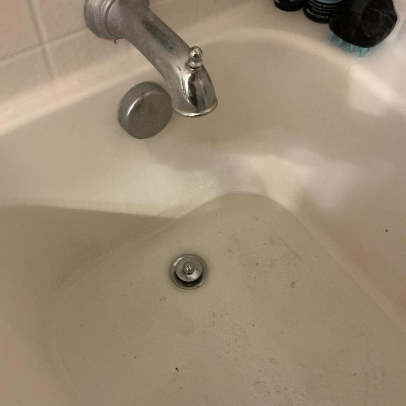 Bathtub drain with popup stopper cleared of hair buildup