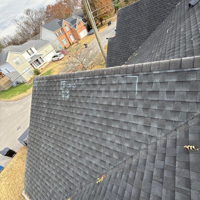 Roof shingles with hail damage marked for inspection