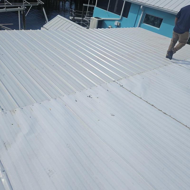 Metal roof panels inspection with visible wear and damage