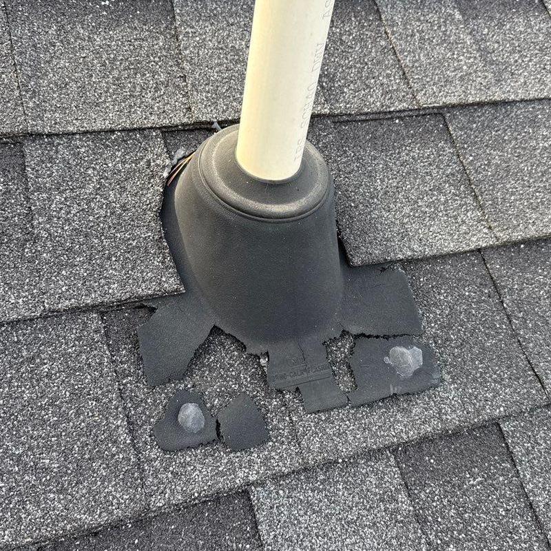 Asphalt shingle roof vent flashing with damage