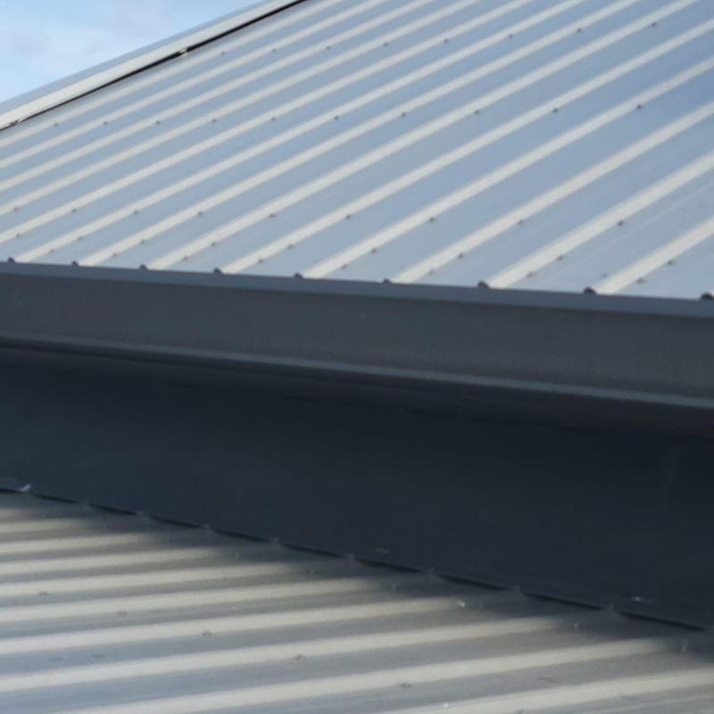 Metal roof panel damage from wind on residential roof