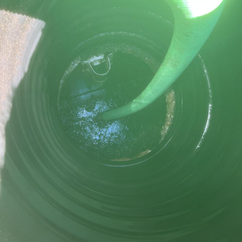 Septic tank pumping with inspection hose inside tank