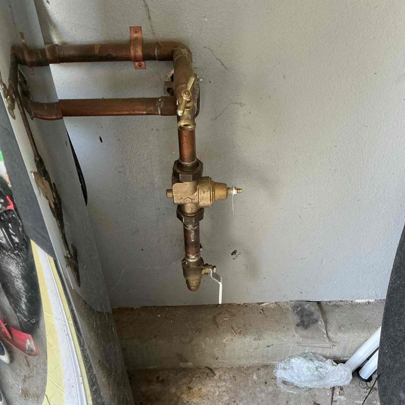 Brass pressure regulator installation on copper piping