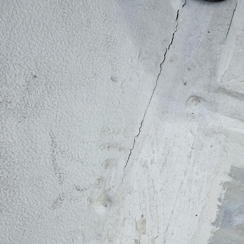 Flat roof membrane with visible crack and damage Flat roof membrane with visible crack and damage