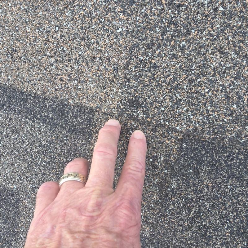 Asphalt shingles with hail damage close-up