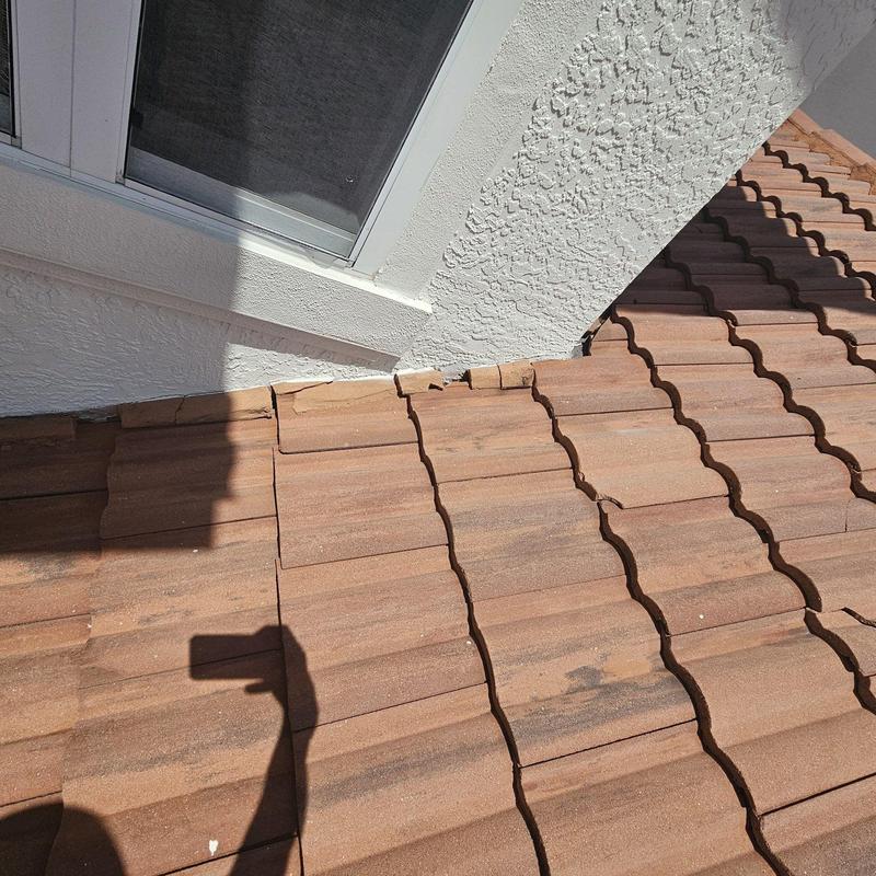 Tile roof cracked tiles near window flashing Tile roof cracked tiles near window flashing