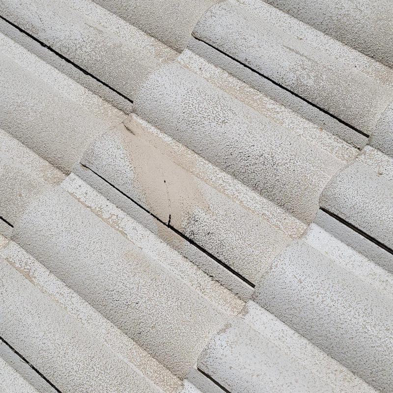 Concrete tile roof with visible crack damage