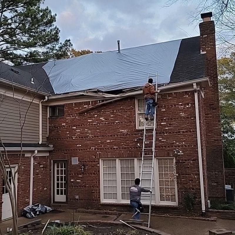 Tarps on damaged roof with ladder access Tarps on damaged roof with ladder access